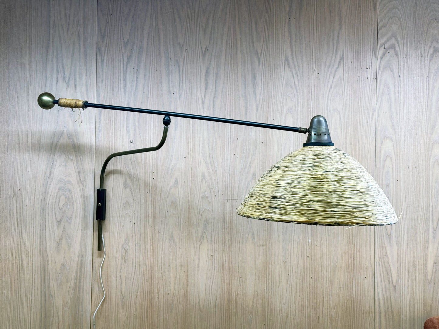 1950s Adjustable French Wall Lamp by Maison Arlus in brass, metal, and rattan