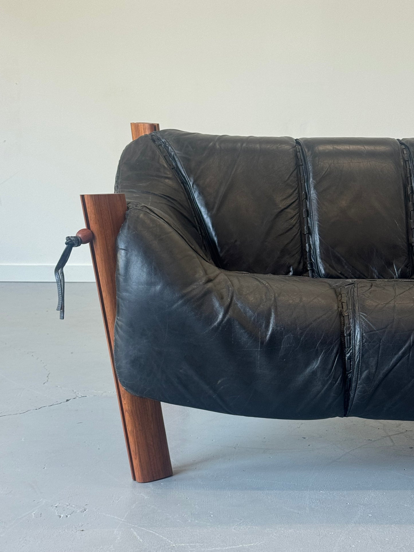 1970s MP-211 Two-Seater Sofa by Percival Lafer in jatobá and original black leather.