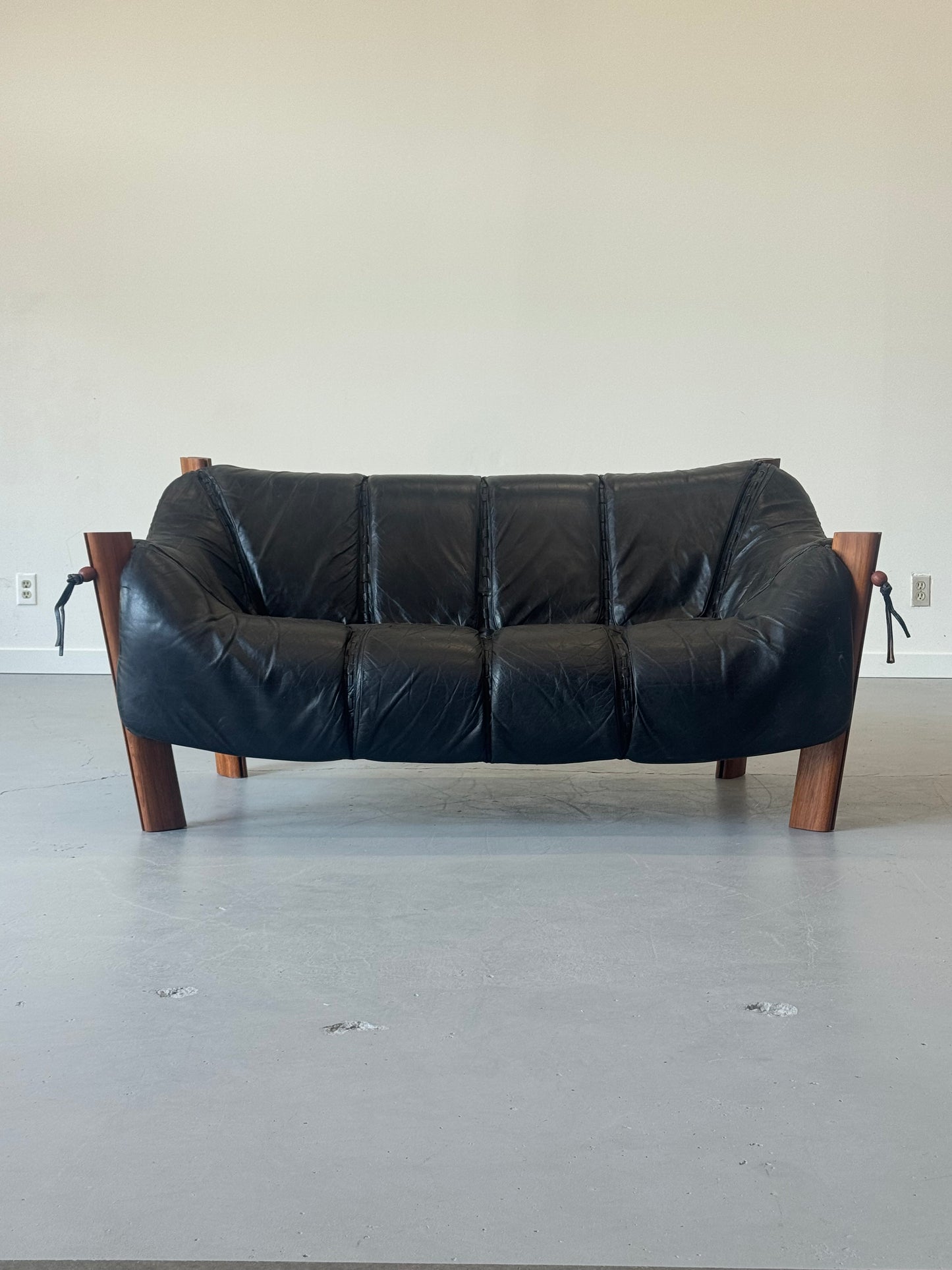 1970s MP-211 Two-Seater Sofa by Percival Lafer in jatobá and original black leather.