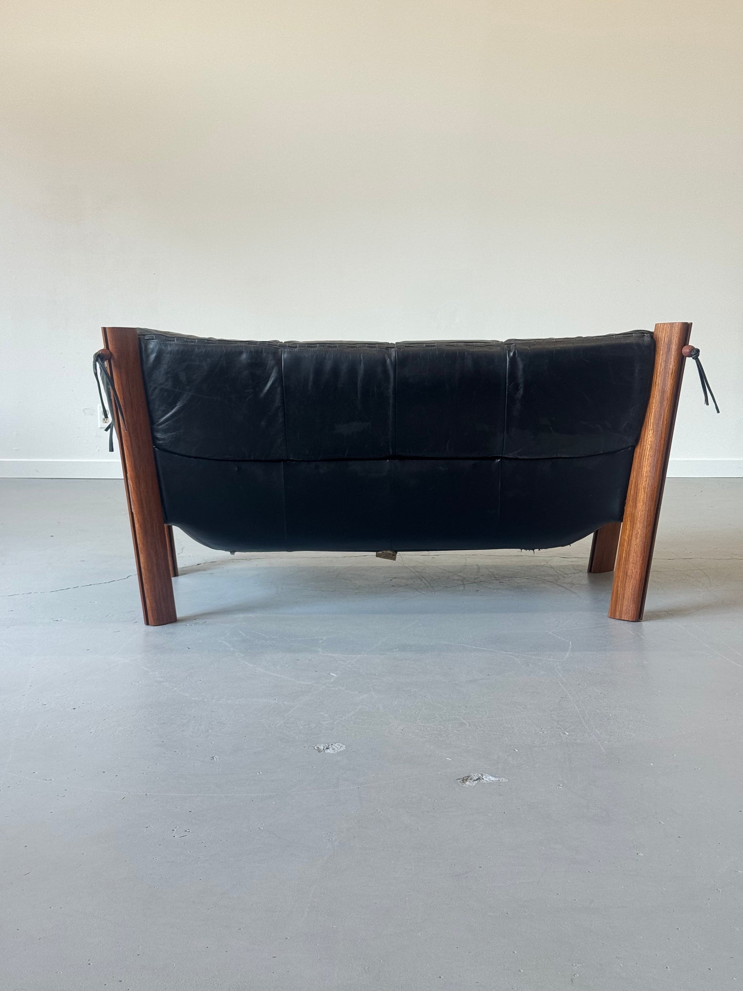 1970s MP-211 Two-Seater Sofa by Percival Lafer in jatobá and original black leather.